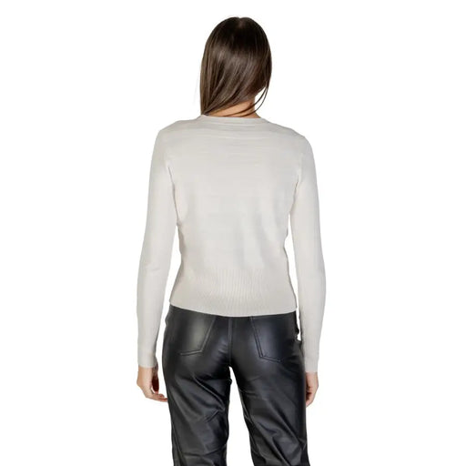 Woman wearing a light-colored long-sleeve top and black leather-look pants with Morgan De Toi White Low V Neck Long Cardigan