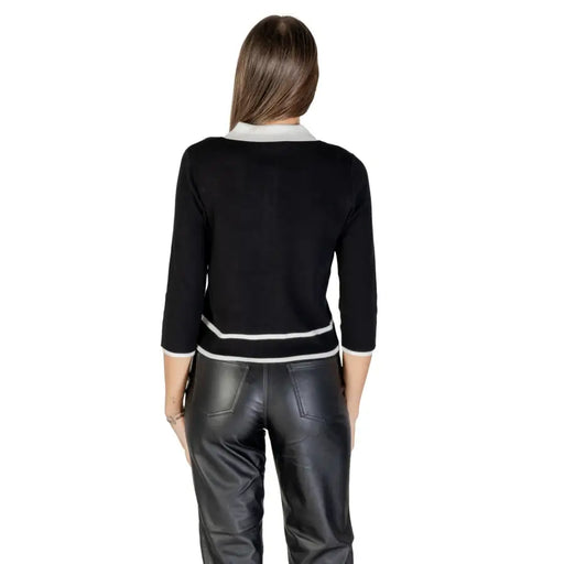 Women’s black and white collared button-front cardigan with three-quarter sleeves and striped hem