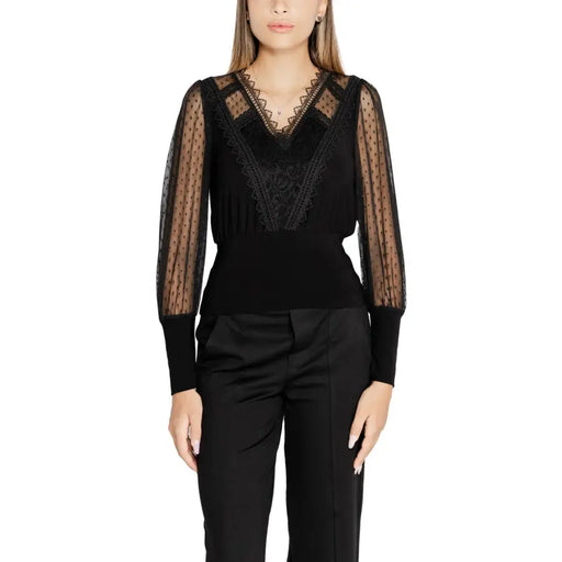 Women’s black long-sleeve V-neck knitwear with sheer polka dot sleeves and lace details