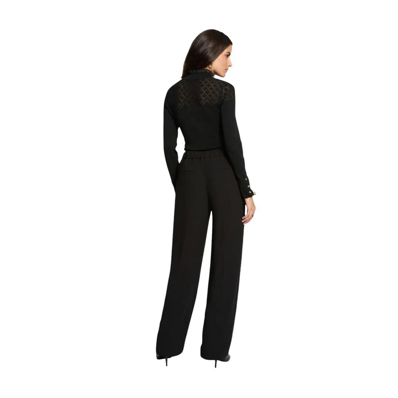 Vue arrière de morgan de toi Combinaison pantalon noire en polyester pour femme, ornée de dentelle transparente, col montant et jambes larges.