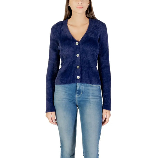 Woman wearing Morgan De Toi navy blue fuzzy cardigan with sparkly buttons
