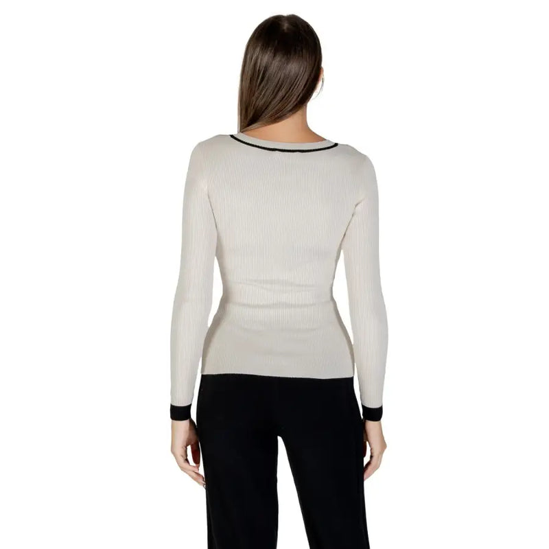 Woman wearing Morgan De Toi beige long-sleeved V-neck knit sweater with black trim