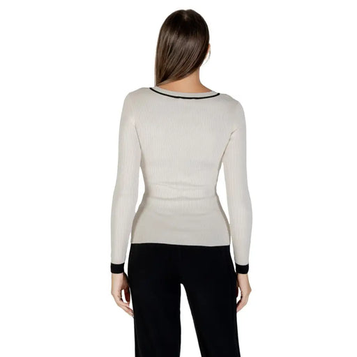 Woman wearing Morgan De Toi beige long-sleeved V-neck knit sweater with black trim