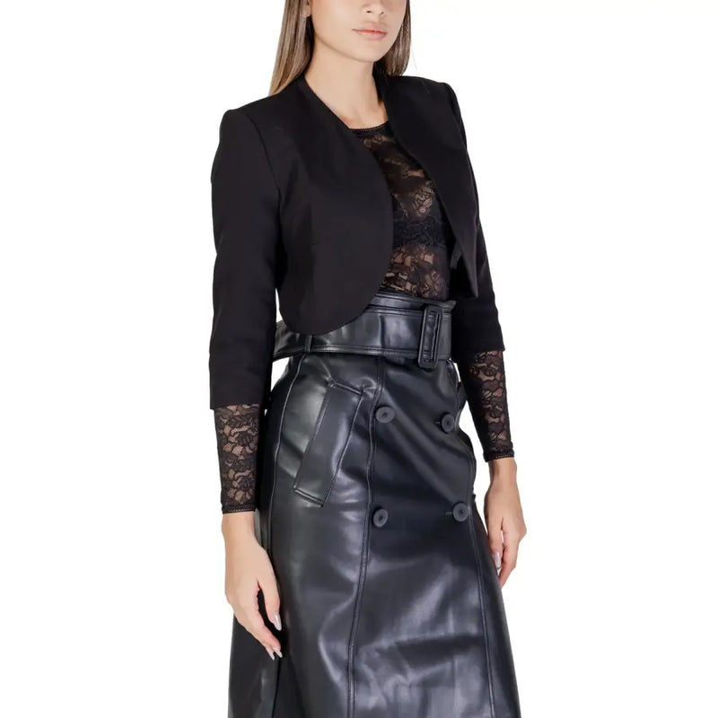 Morgan De Toi Gilet noir pour femme à manches 3/4 orné de dentelle, porté avec une jupe noire en similicuir.