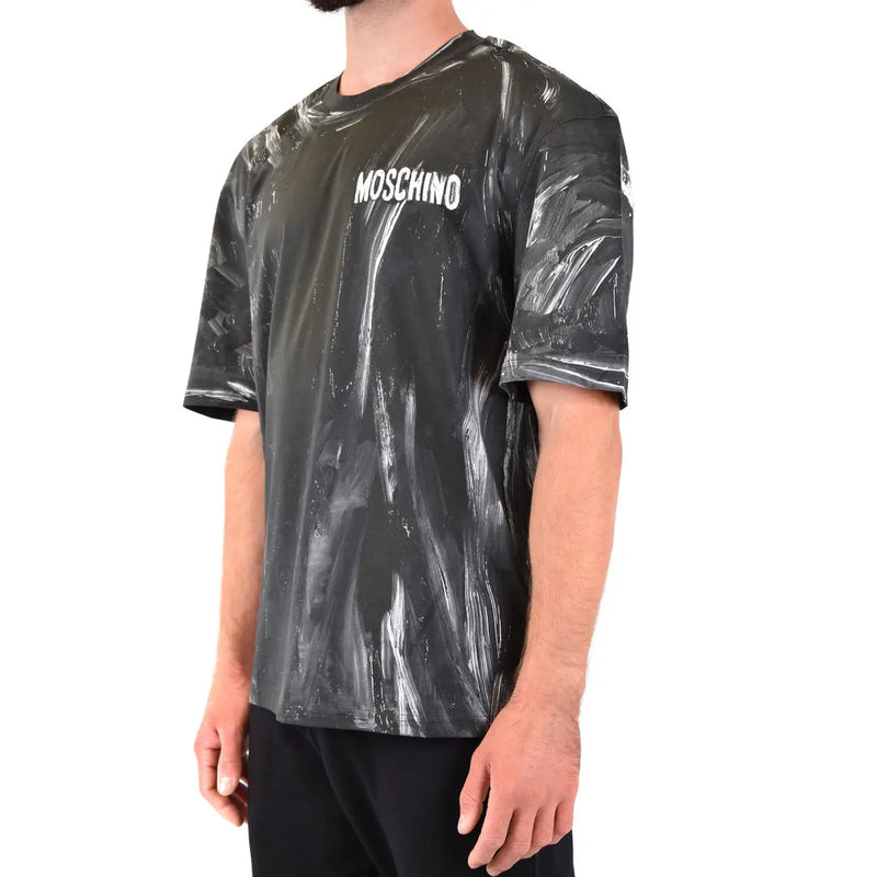 Noir Moschino hommes t-shirt avec un motif brillant à éclaboussures de peinture et un logo blanc sur la poitrine