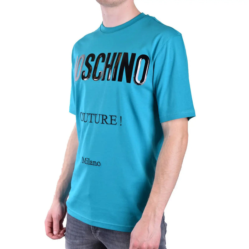 Turquoise moschino men t-shirt featuring bold black and silver lettering with words moschino couture and milano