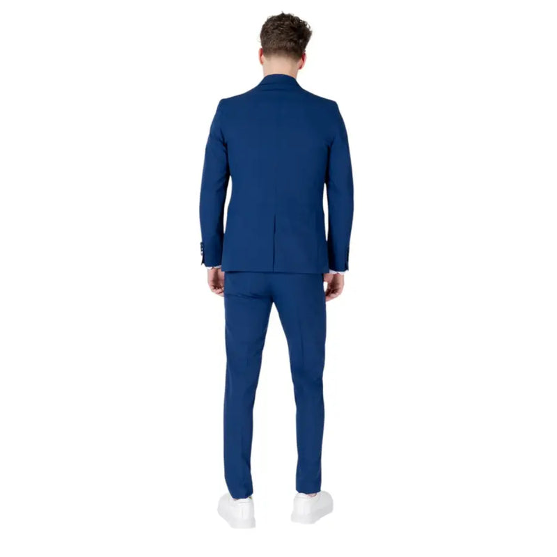 Men’s slim-fit blue suit with lapel collar and white sneakers displayed in Mulish collection