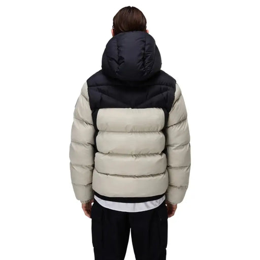 Beige and black puffer jacket with hood, quilted design.