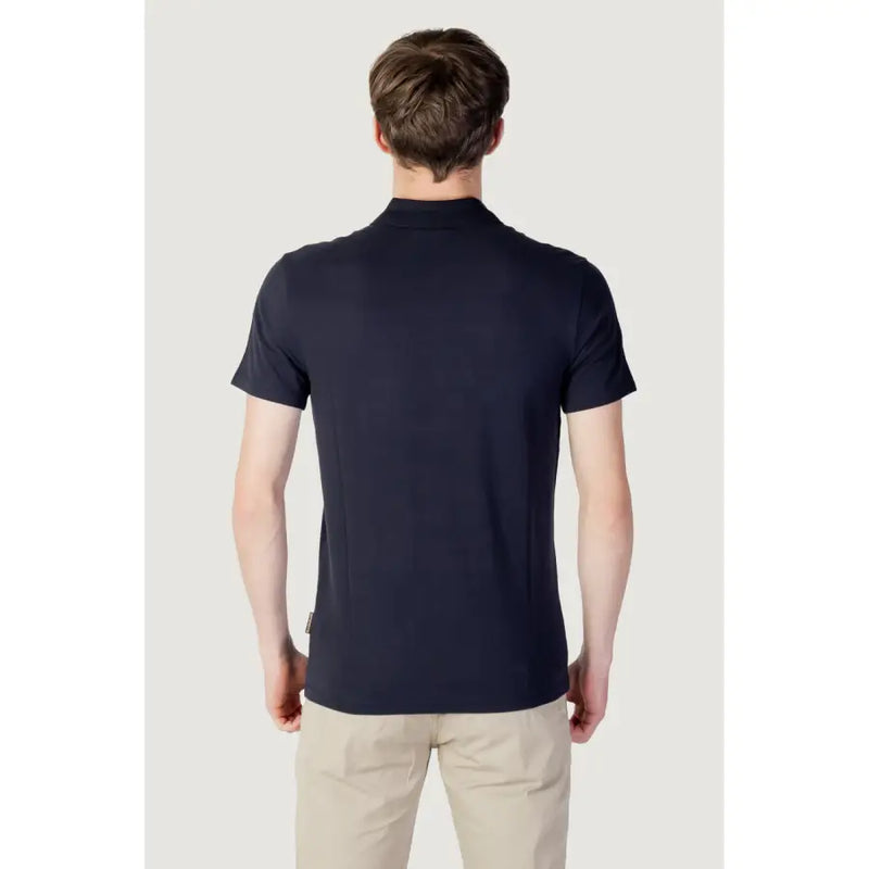 Navy blue polo shirt with white logo and ribbed collar, made of cotton.