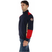 Napapijri Sweat-shirt à col roulé bleu en coton pour homme, avec empiècements en polaire bicolores bleu marine et rouge et écusson logo sur la manche gauche.