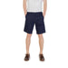 Navy blue chino shorts displayed in a men’s ensemble with white chinos and brown boat shoes