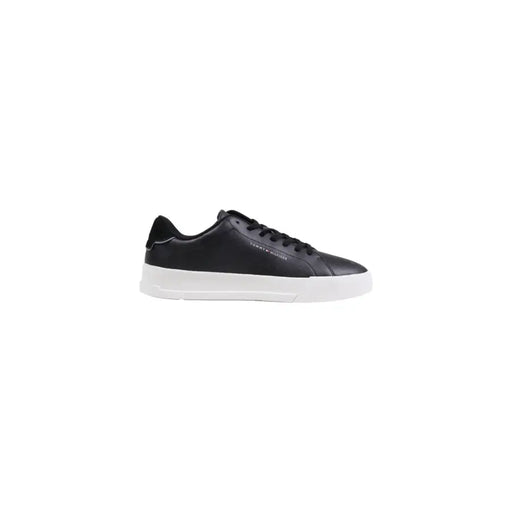 Black leather low-top sneaker with white sole and laces, classic design.