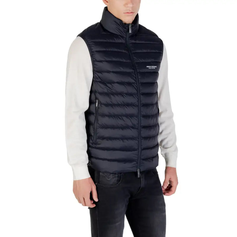Black quilted puffer vest with high collar and front zipper featuring Armani Exchange logo on chest in navy blue puffer vest product