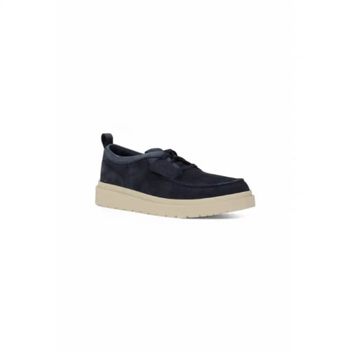 Navy blue suede moccasin shoe displayed in a product listing image
