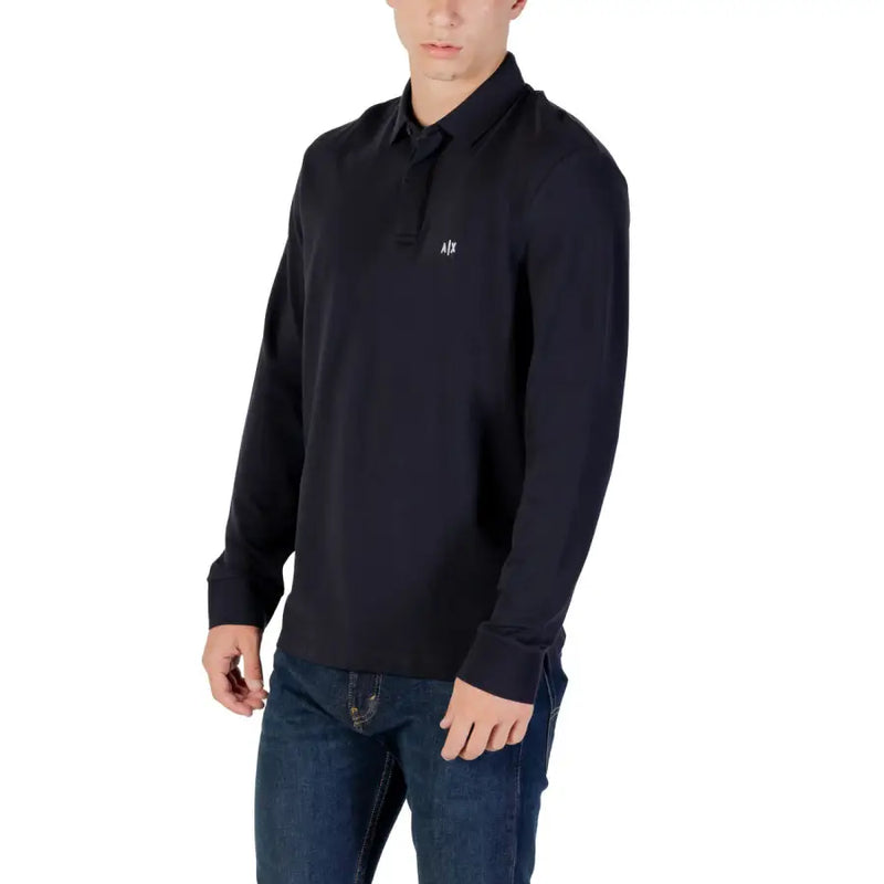Polo noir à manches longues avec logo blanc discret sur la poitrine, adapté aux tenues décontractées et professionnelles.