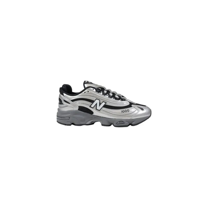 Silver new balance sneaker with black accents and white logo.
