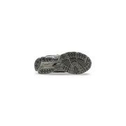 New Balance Baskets montantes pour homme 1906r grises en synthétique avec semelle en caoutchouc gris à motif géométrique et semelle intermédiaire translucide.