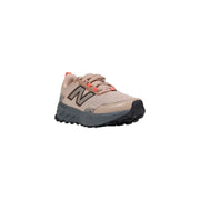 Beige new balance trail running shoe with pink accents and textured sole.