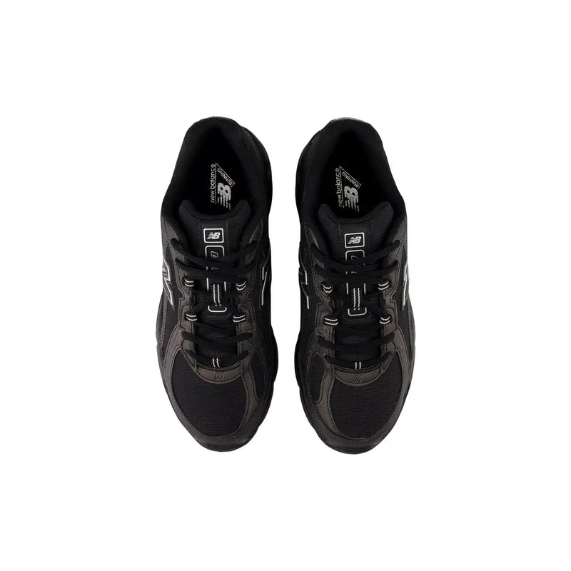 New Balance Baskets homme noires en matière synthétique, modèle slip-on avec empiècements en mesh gris et détails en caoutchouc noir.
