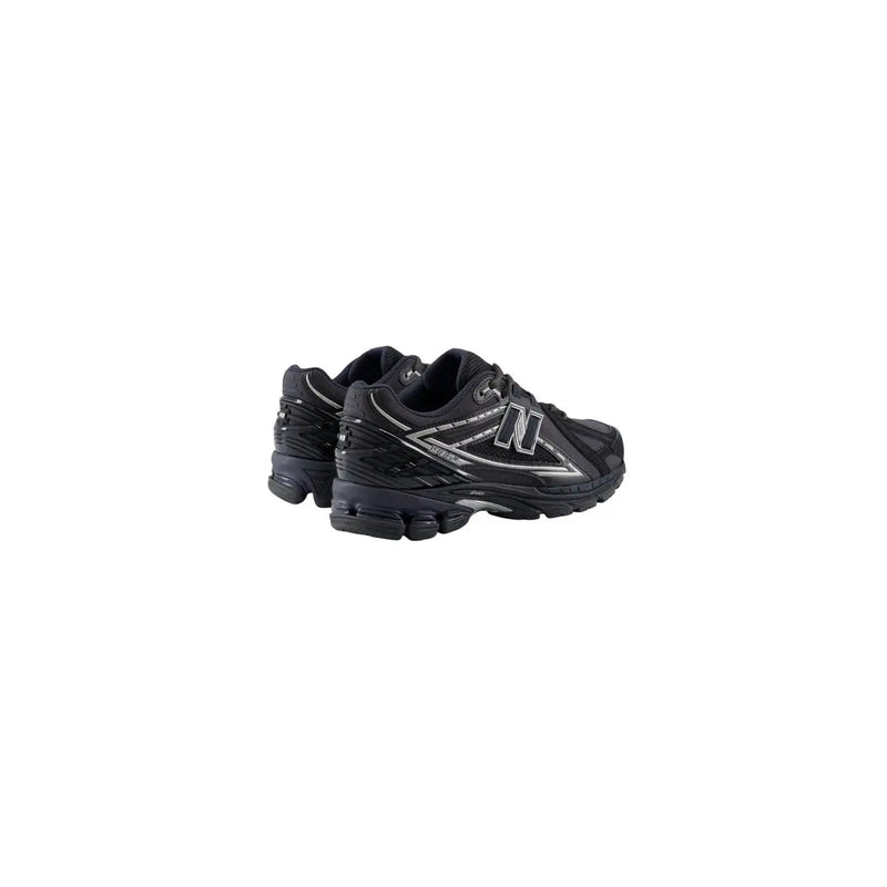 New Balance Baskets homme noires en synthétique avec détails argentés et semelle en caoutchouc texturé pour la course
