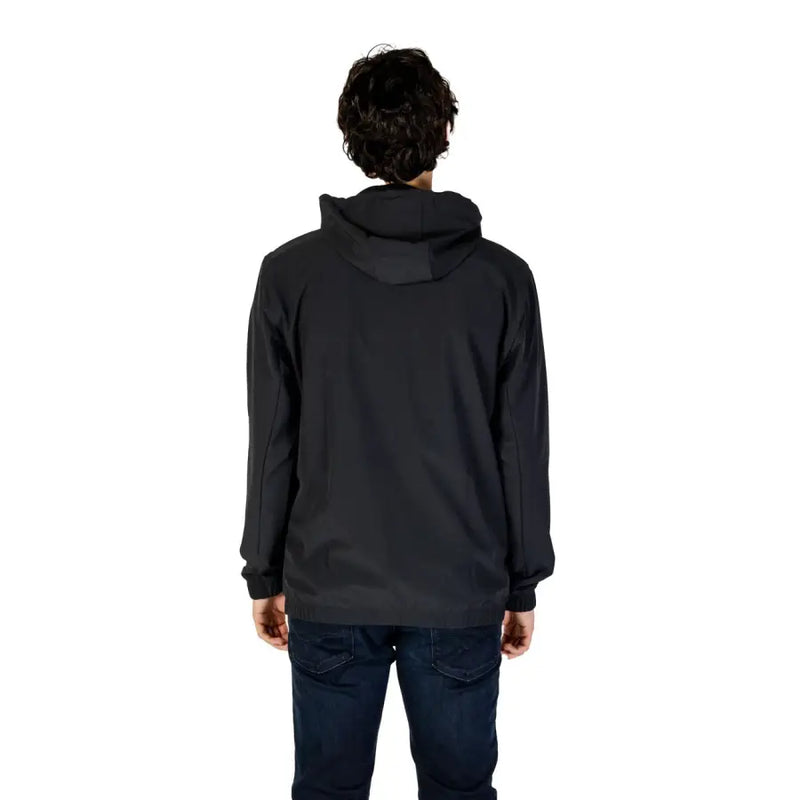 Men’s black hooded winter blazer paired with dark blue jeans, stylish and warm