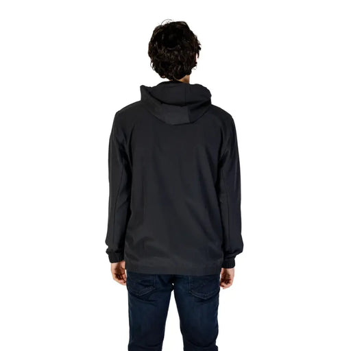 Men’s black hooded winter blazer paired with dark blue jeans, stylish and warm