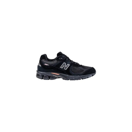 Black new balance running shoe with white accents and mesh upper.