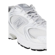 New Balance women grey faux leather sneakers with white running shoe design and silver mesh accents