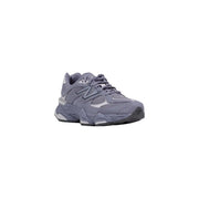 New Balance women grey suede sneakers featuring a chunky layered sole and breathable mesh upper