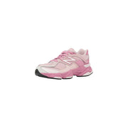 New balance women pink suede sneakers with white accents and chunky sole for stylish casual wear