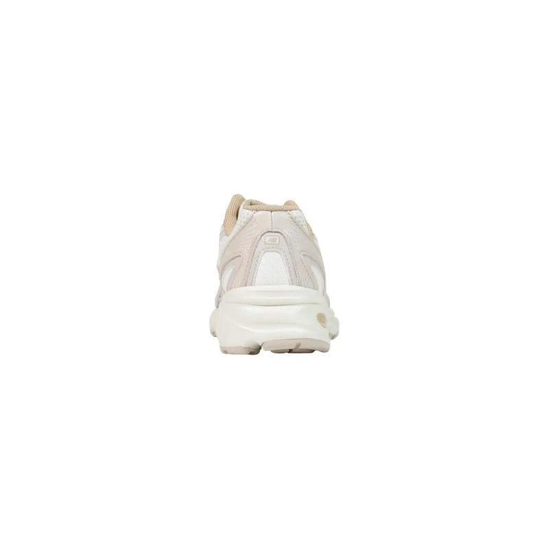 Cream-colored New Balance women running sneaker with white rubber sole and beige synthetic heel tab accents
