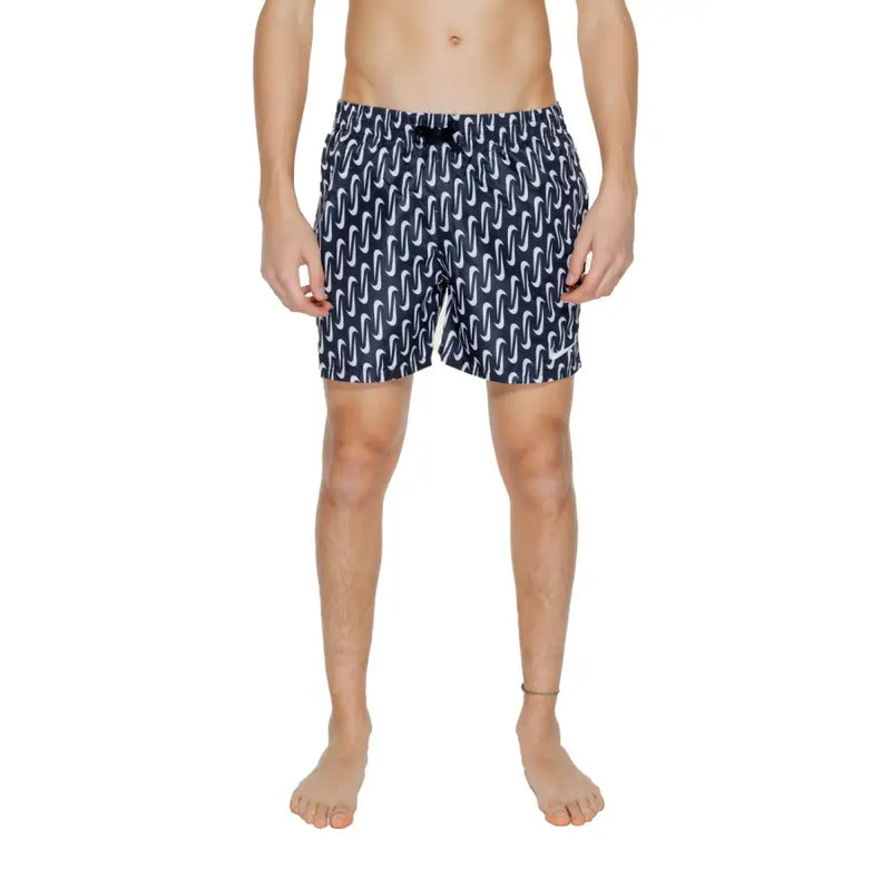 Navy blue Nike men’s swim trunks with white wavy pattern black drawstring waistband 100 percent polyester