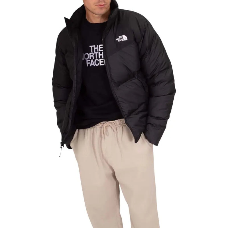 Black puffer jacket with hood and drawstrings, the north face brand.