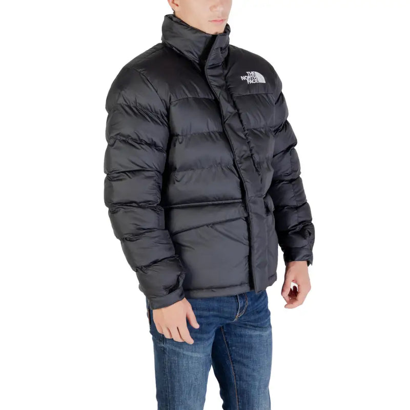 Black puffer jacket with the north face logo, made of synthetic material.