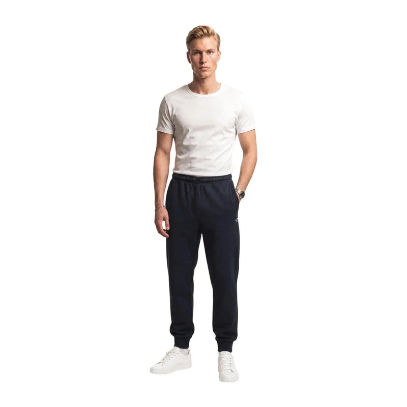Pantalon de jogging The North Face pour homme, en molleton de coton noir, bleu marine, avec taille élastique et poignets côtelés.