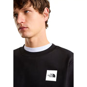 Sweat-shirt The North Face pour homme, en coton noir, coupe classique, avec un logo rectangulaire blanc sur la poitrine.
