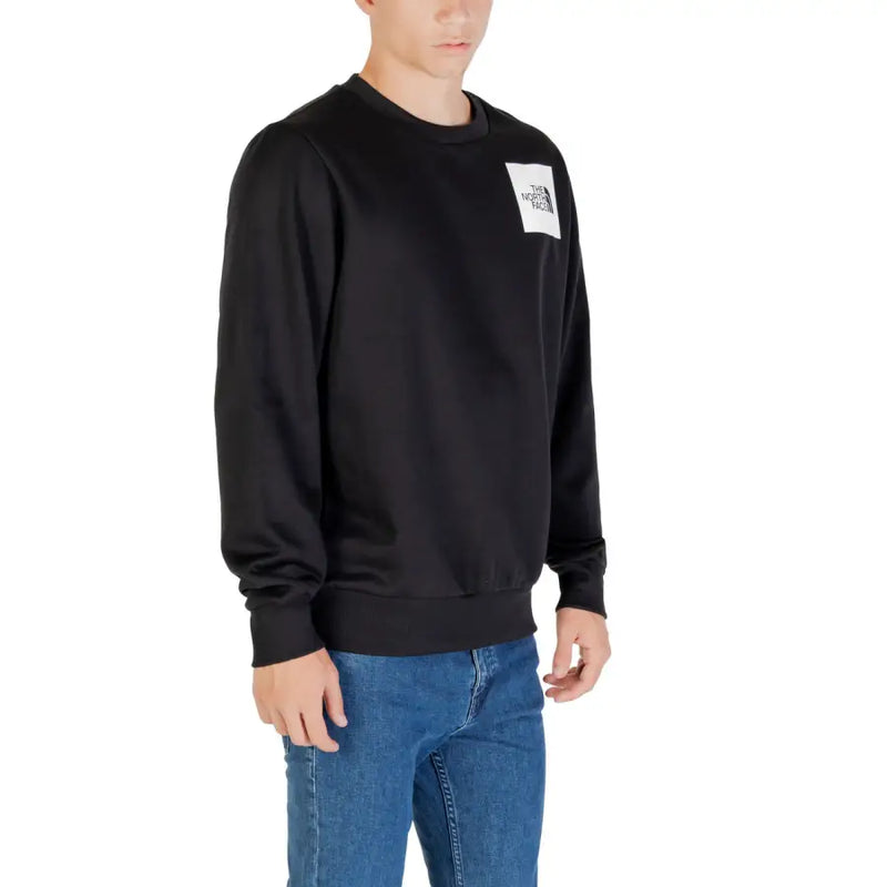 Men’s black crewneck sweatshirt with white square logo patch from The North Face