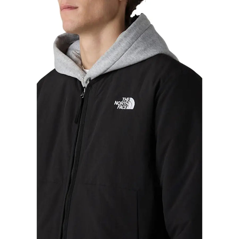 Blazer homme The North Face, veste longue en nylon noir zippée avec capuche grise et logo blanc sur le devant
