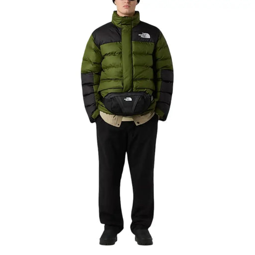 Green and black puffer jacket with a classic north face logo on the chest.
