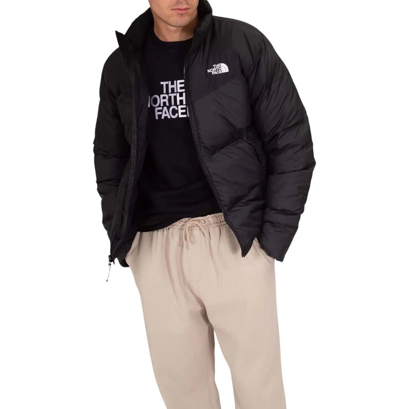 Doudoune The North Face pour homme, noire, matelassée, avec logo sur la poitrine (vue de face).
