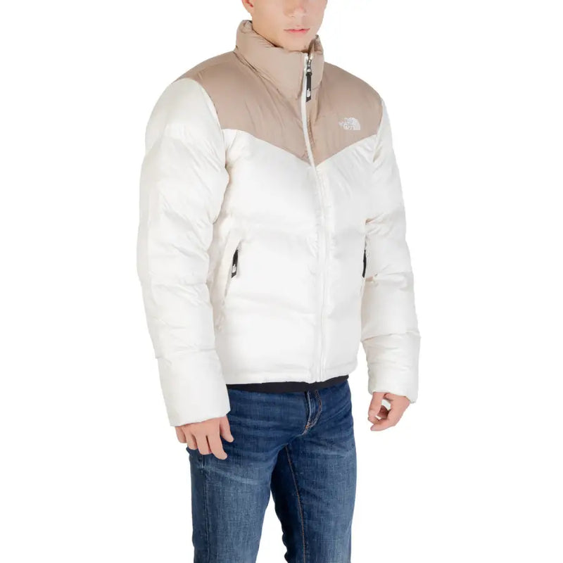 Beige and white north face puffer jacket with a high collar.