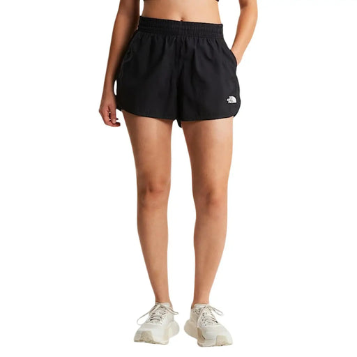 Le short noir en polyester pour femme de The North Face présente un logo blanc sur la jambe gauche, dans un design athlétique et élégant.