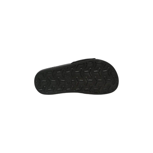 Les mules The North Face pour femmes, noires, présentent une semelle en caoutchouc noir à motif géométrique.