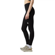 Legging noir taille haute pour femme The North Face, en polyester et élasthanne, avec un logo blanc discret sur la cuisse.