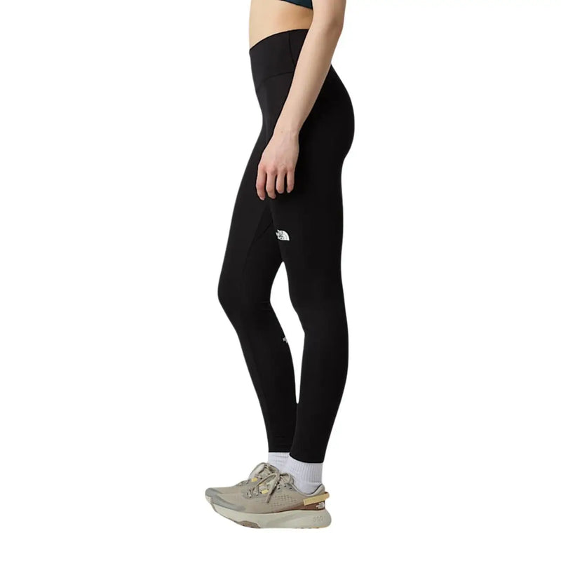 Legging noir taille haute pour femme The North Face, en polyester et élasthanne, avec un logo blanc discret sur la cuisse.