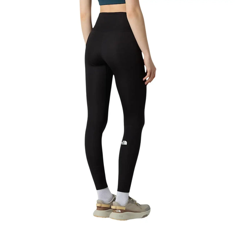 Legging noir taille haute The North Face pour femme, en polyester élasthanne, avec logo blanc sur la cuisse gauche.