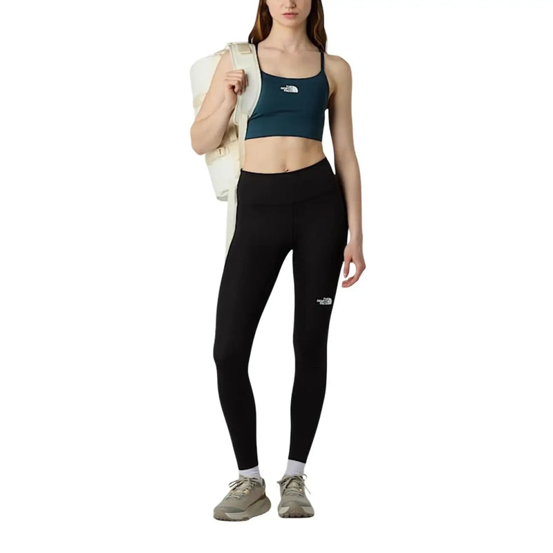 Legging noir taille haute avec logo blanc sur la cuisse gauche, en polyester et élasthanne, de la marque The North Face (pantalon femme).