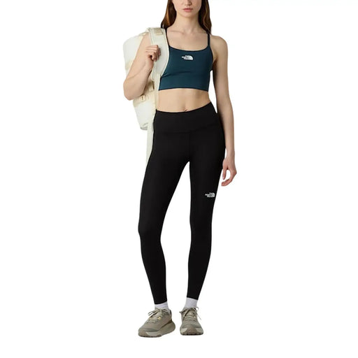 Legging noir taille haute avec logo blanc sur la cuisse gauche, en polyester et élasthanne, de la marque The North Face (pantalon femme).
