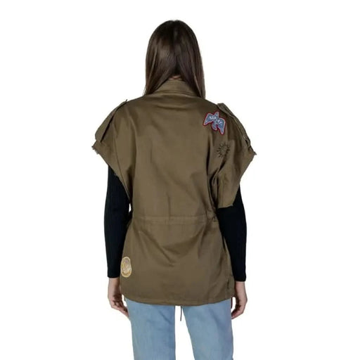 Olive green military-style vest with patches over Replay Women’s Classic Short Sleeve Shirt