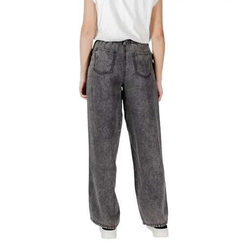 Wide-leg gray denim only women black lyocell jeans with faded distressed texture and classic back pockets shown from back side